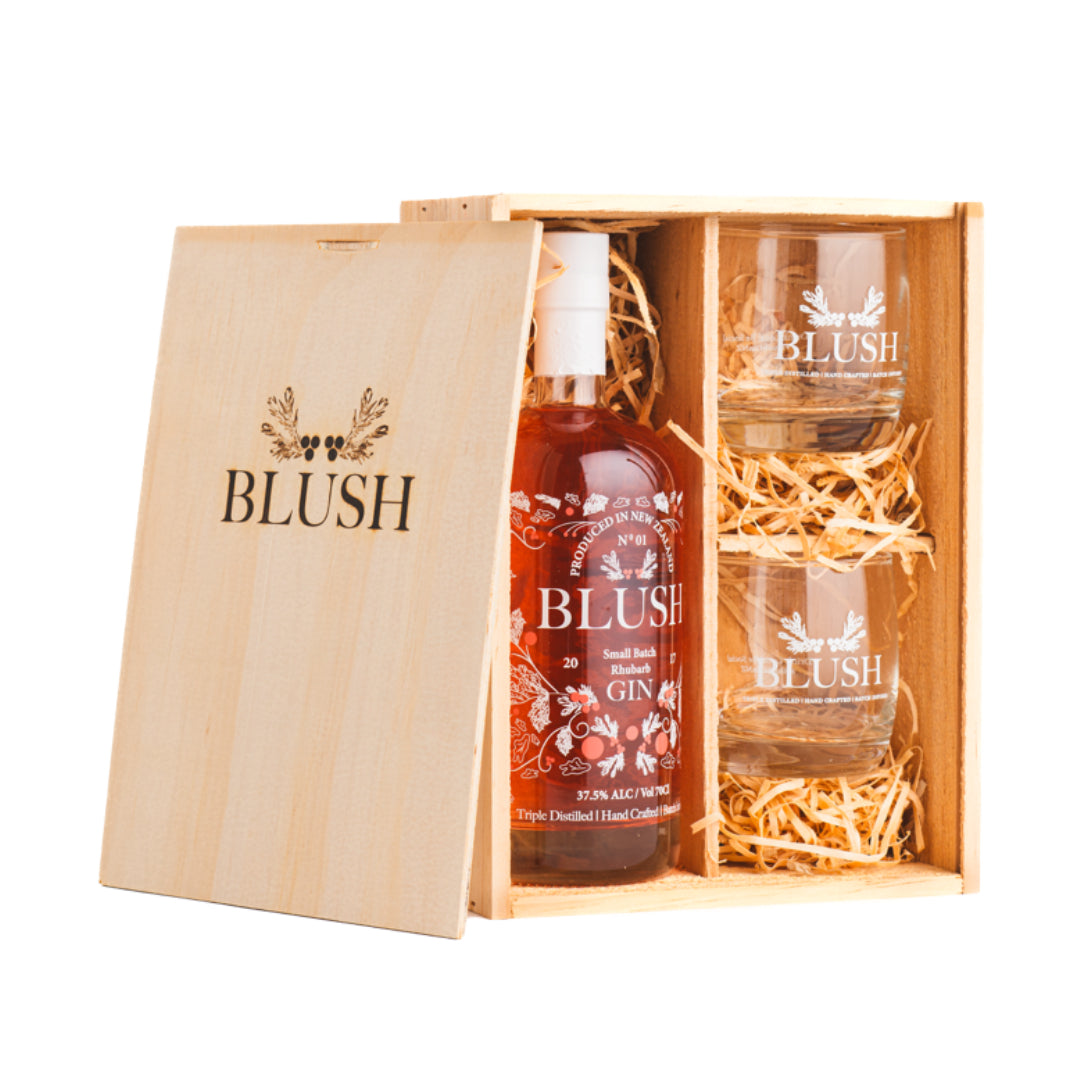 A Blush Gin gift set containing a 700ml bottle of Blush Gin and two gin drinking glasses, presented in a wooden craft gift box.