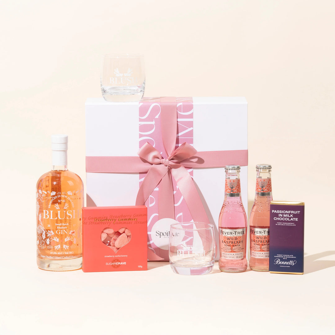 A gift box set with a blush pink theme, including a bottle of Blush Rhubarb Pink , Fever Tree Twin Tonics, Sugar Crave Strawberry Gummies, a Bennetts Chocolate Bar, and Blush gin glasses.